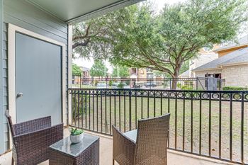 Private balcony with outdoor seating and backyard view